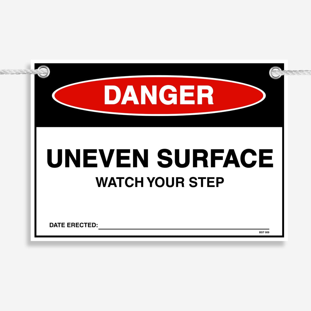 Layflat view of the Danger Uneven Surface Watch Your Step tag showing the date erected field.