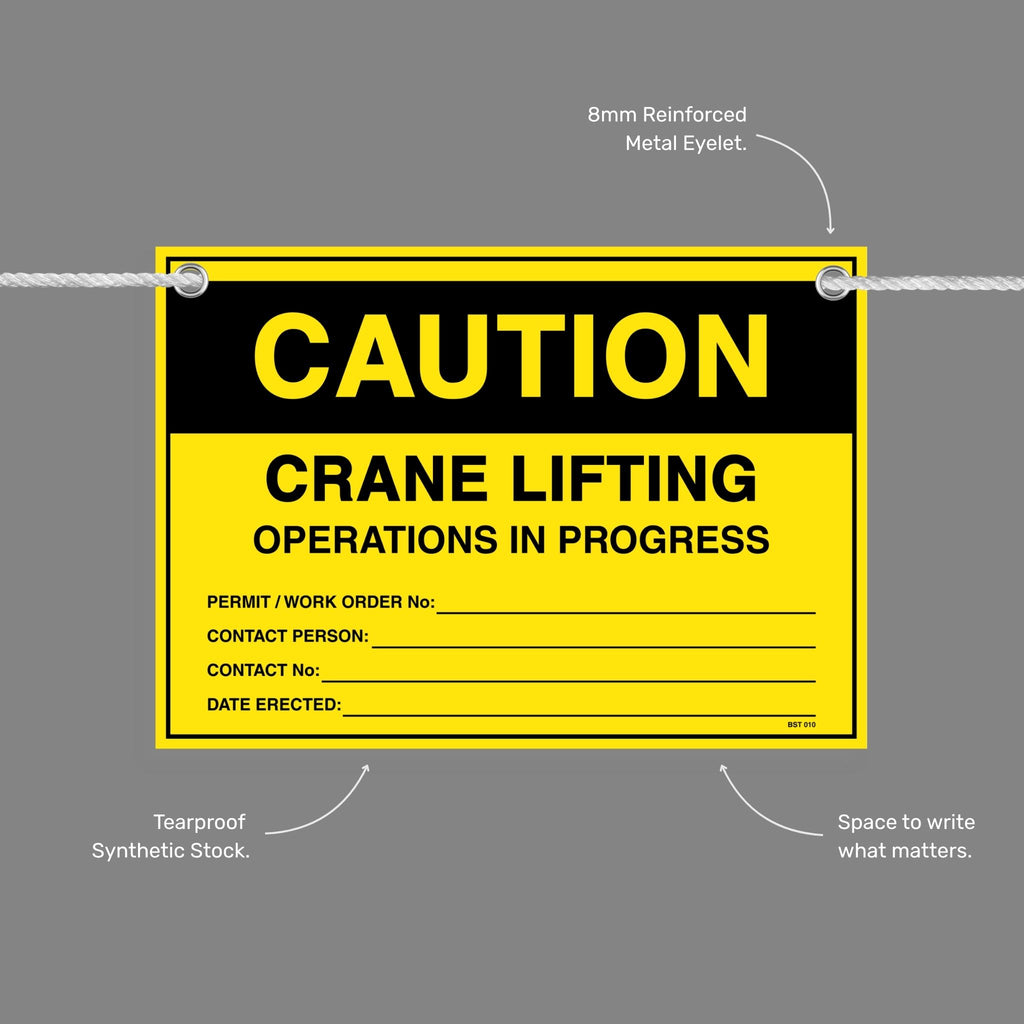 Caution Crane Lifting Operations In Progress flag tag with callouts showing the 8mm reinforced metal eyelet, tearproof synthetic stock and write in space.