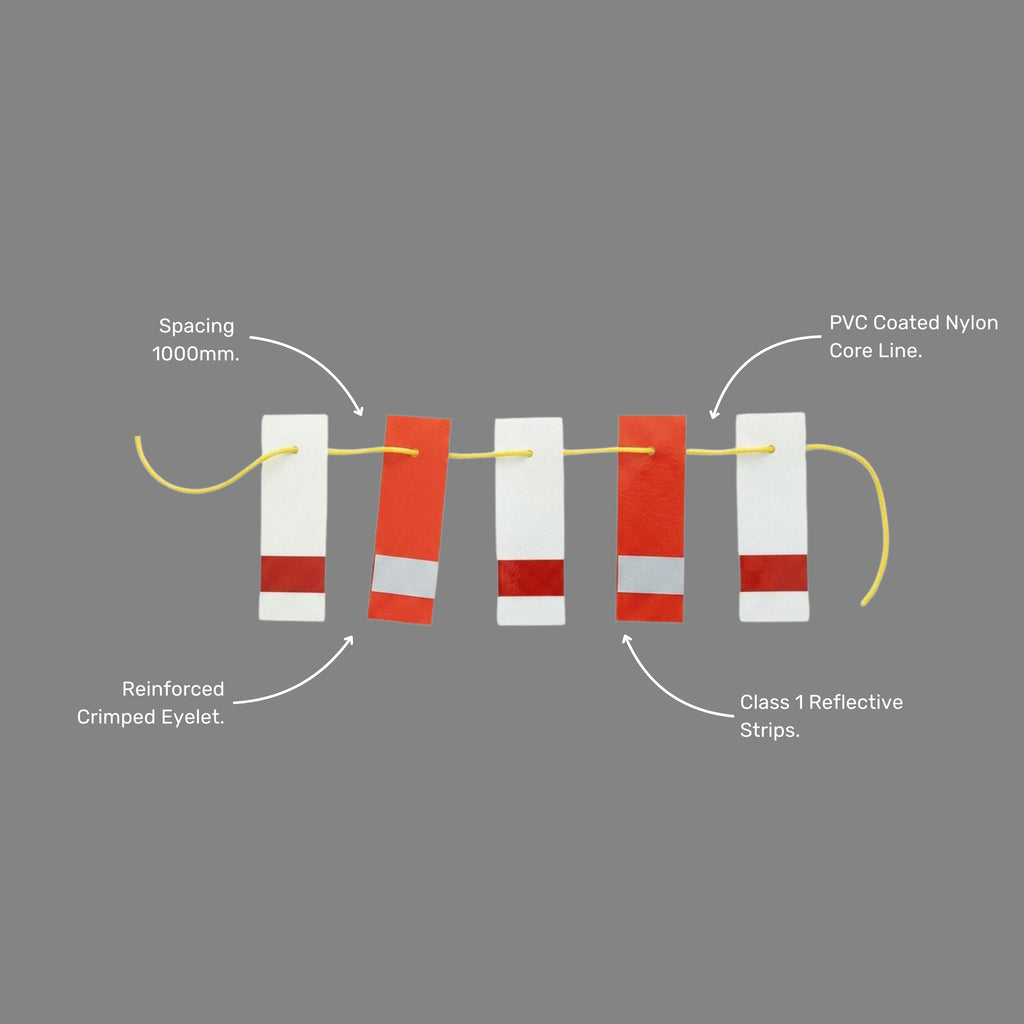 BMT 016 red and white reflective bunting line shown at an angle, highlighting the alternating red and white flag pattern on yellow cord for maximum visibility in low light and night time conditions on construction and mining worksites.