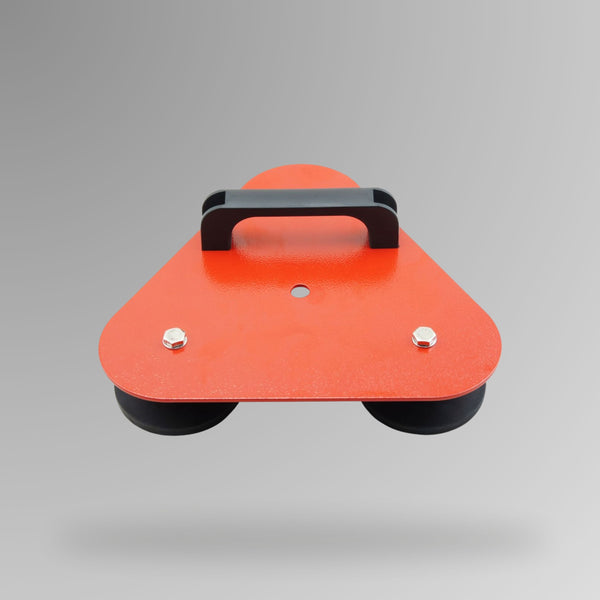 BVS 009 mine flag magnetic base shown from above, featuring an orange powder coated triangular steel plate with black rubber magnetic pads on the underside, a central mounting hole and black carry handle on top.