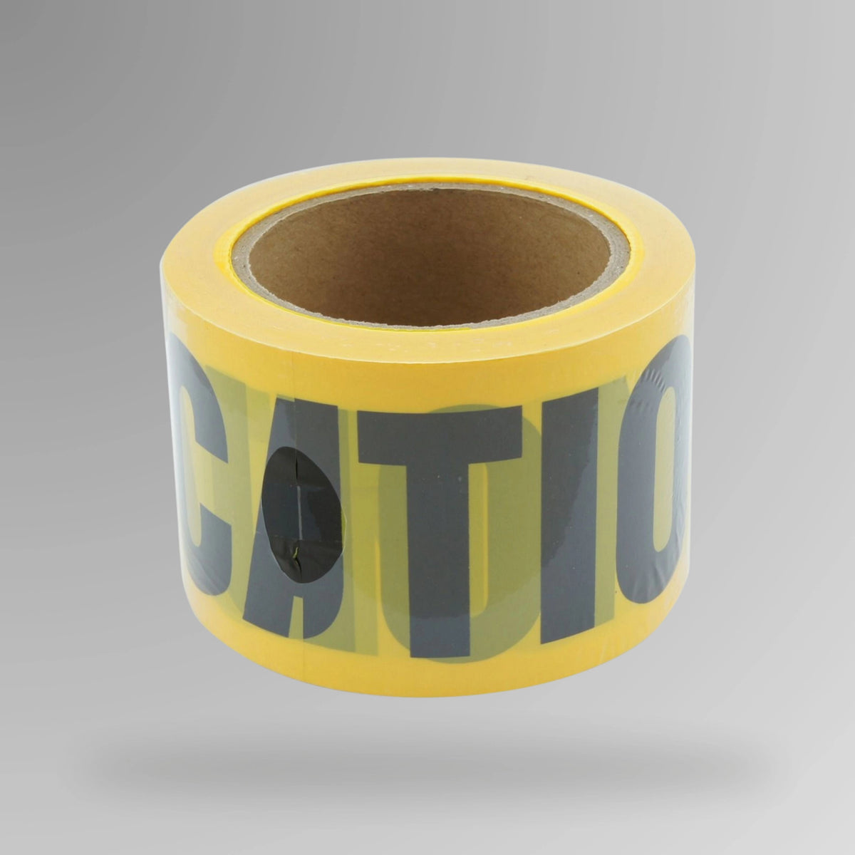 Upright roll of yellow caution barrier tape showing double side black stripes and caution text printing on polyethylene material