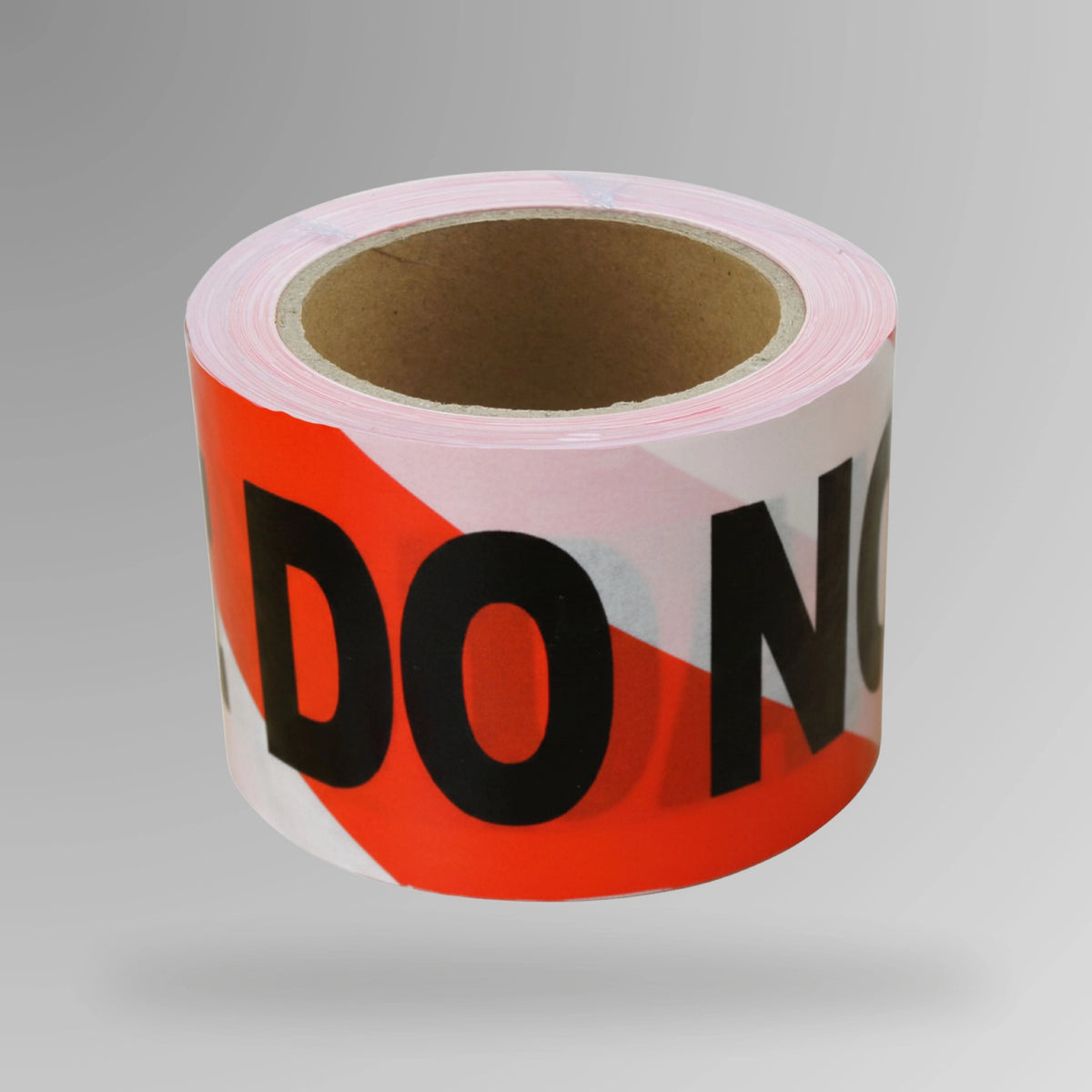 Upright roll of red and white danger do not enter barrier tape showing striped pattern with warning text printed on 2 ply polyethylene tube