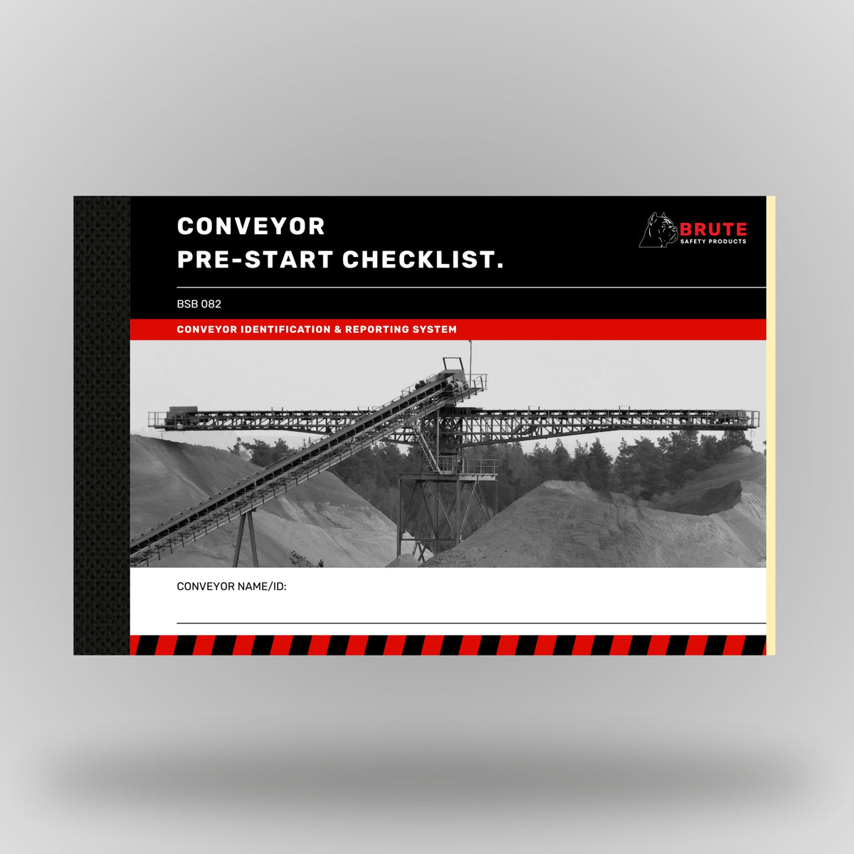Brute Safety Products BSB 082 Conveyor Pre-Start Checklist Book in A5 landscape format, showing black cover with red banner, Brute Safety logo and greyscale image of a large overland conveyor system at a quarry or mine site with aggregate stockpiles in the background. Includes conveyor name and ID field.