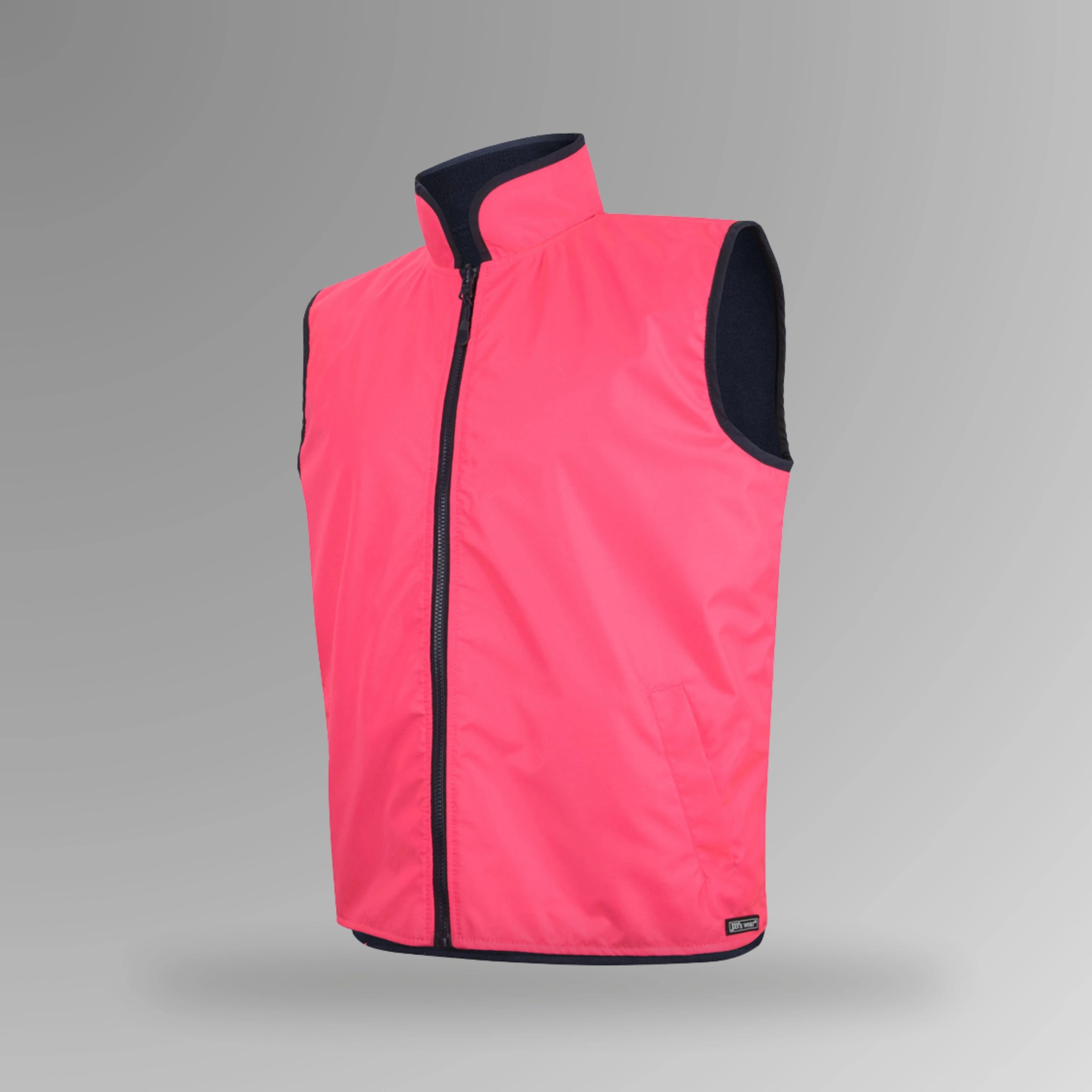 BSC 103 pink and navy hi vis reversible vest in portrait orientation showing fluorescent pink shell with navy fleece lining visible at collar and front pockets