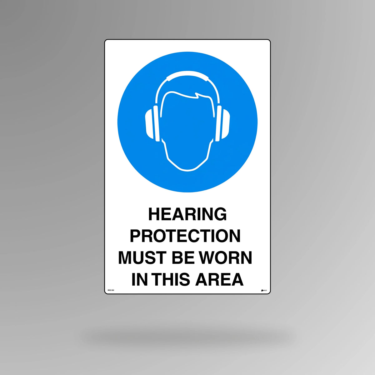 BSS 002 blue and white mandatory safety sign in portrait orientation featuring ear defenders symbol with text stating hearing protection must be worn in this area