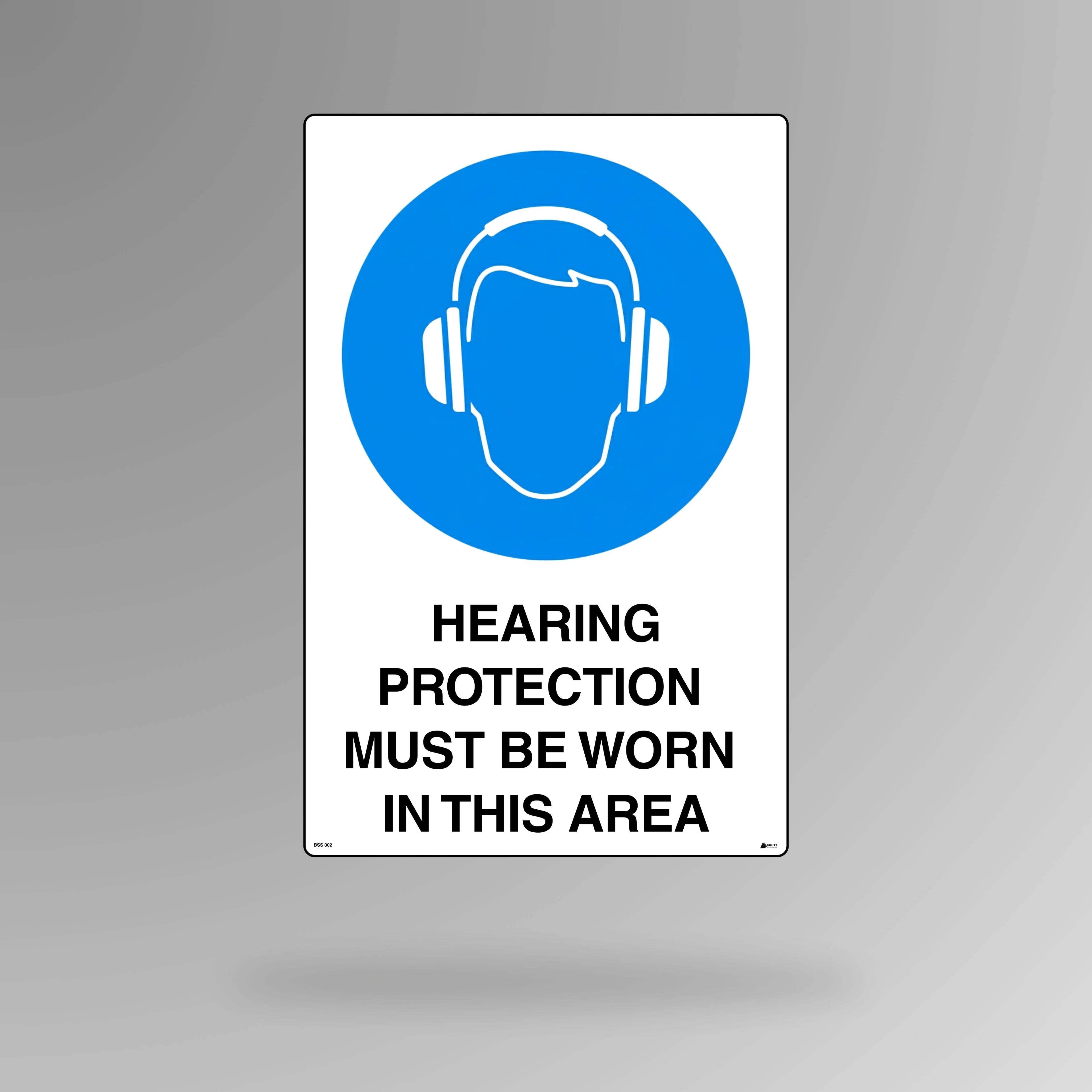 BSS 002 blue and white mandatory safety sign in portrait orientation featuring ear defenders symbol with text stating hearing protection must be worn in this area