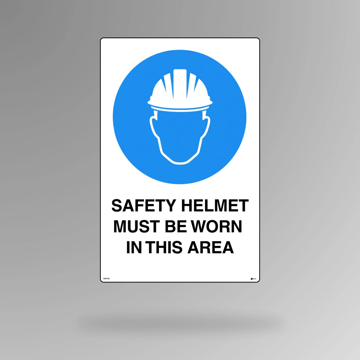 BSS 007 blue and white mandatory safety sign in portrait orientation showing hard hat symbol with text stating safety helmet must be worn in this area