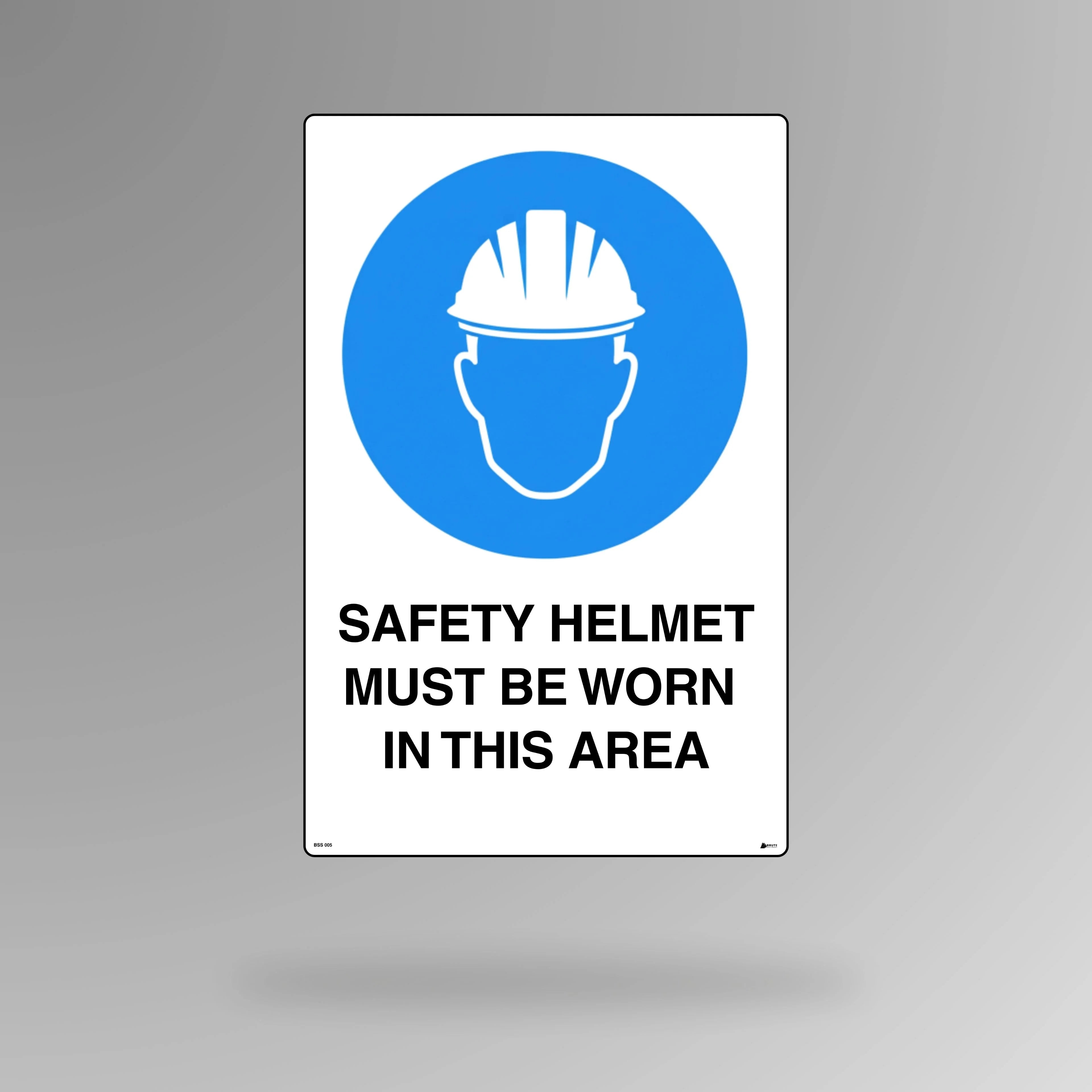 BSS 007 blue and white mandatory safety sign in portrait orientation showing hard hat symbol with text stating safety helmet must be worn in this area