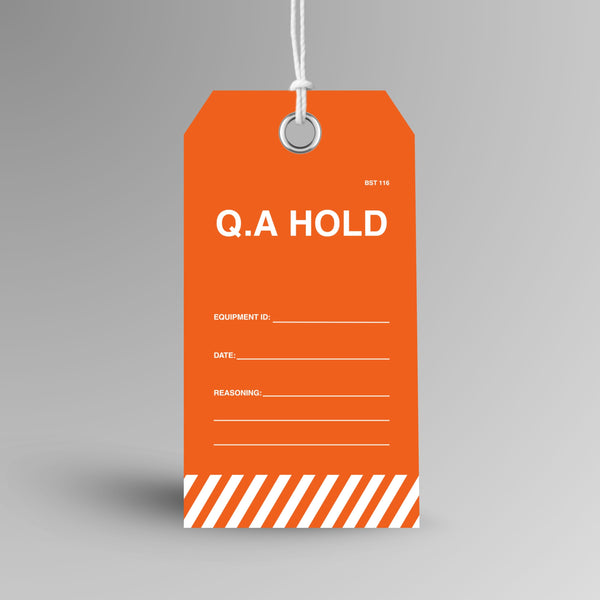 BST 116 Q.A Hold Tag upright view showing bright orange tag with bold white Q.A Hold text and orange and white hazard stripe detail on front face