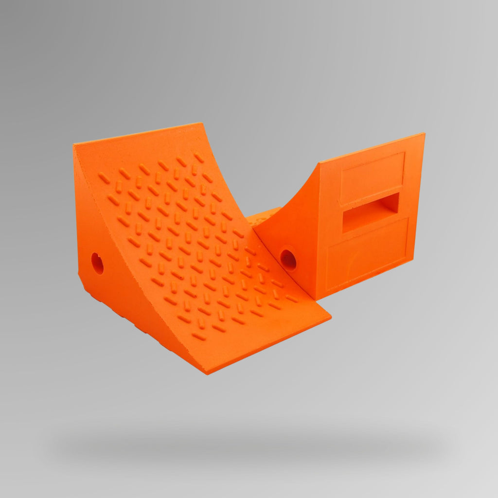 Orange PU Wheel Chock 20t Rated shown upright, displaying the built-in handle and rope connection through-hole. 275 x 205 x 195 mm. Brute Safety Products.