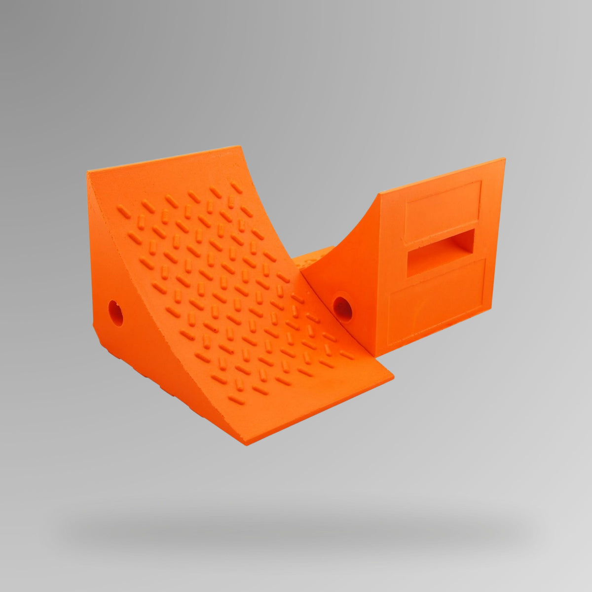 Orange PU Wheel Chock 20t Rated shown upright, displaying the built-in handle and rope connection through-hole. 275 x 205 x 195 mm. Brute Safety Products.