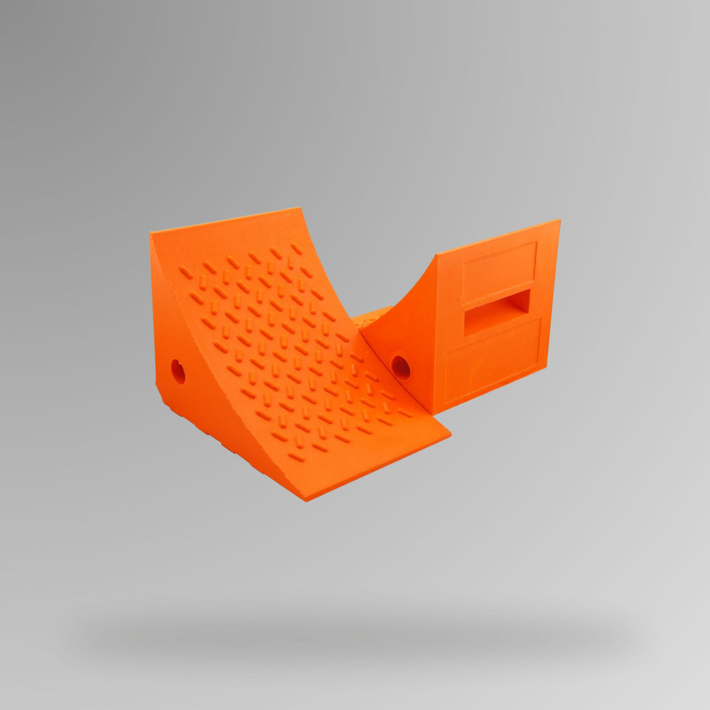 Orange PU Wheel Chock 5t to 6t Rated shown upright, displaying the built-in handle and rope connection through-hole. 200 x 174 x 147 mm. BVS 012. Brute Safety Products.