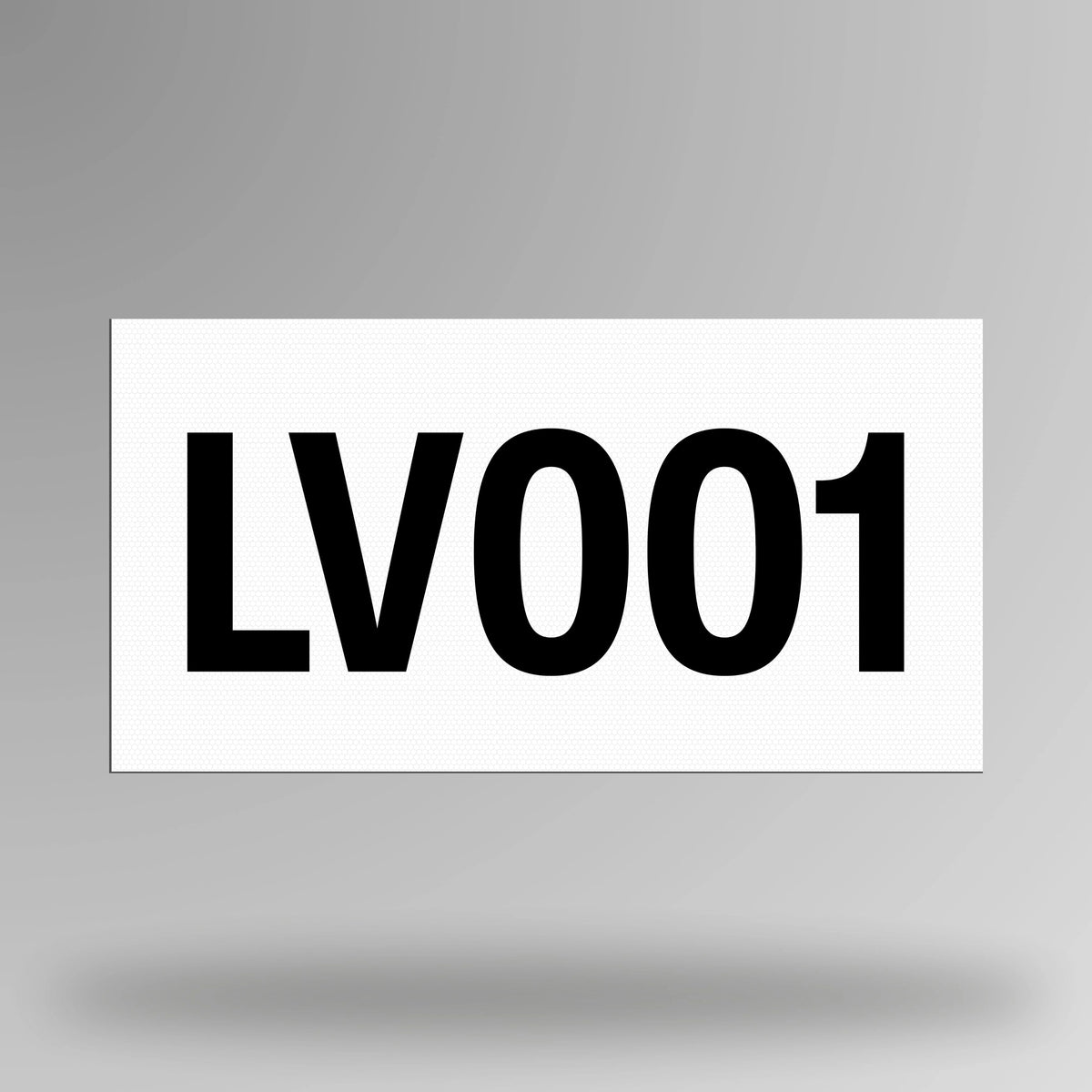 White reflective magnetic asset decal displayed upright showing bold black printed asset number and magnetic backing