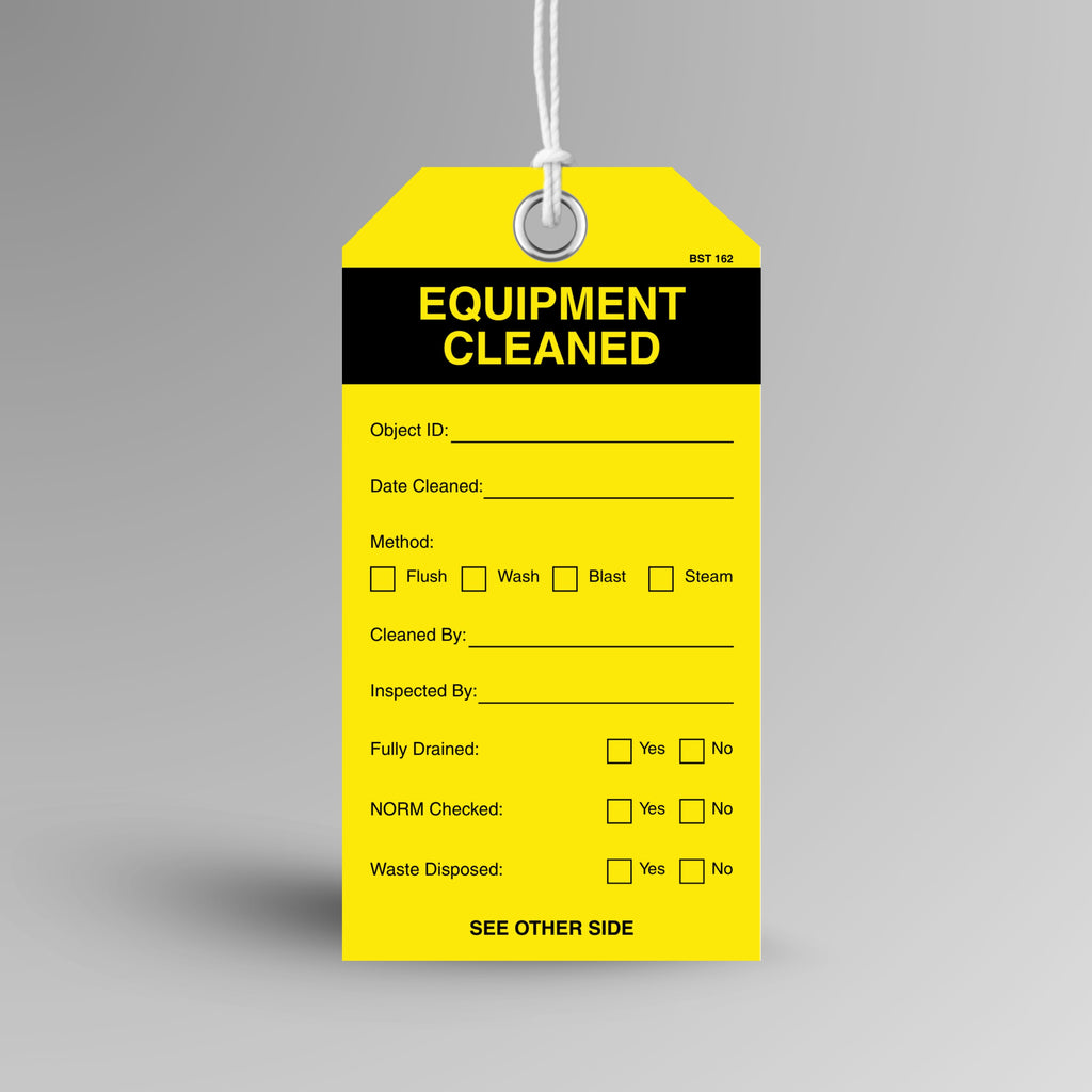 Yellow and black BST 162 Equipment Cleaned tag hanging from white string through a metal eyelet, with object ID, method, fully drained, NORM checked and waste disposed fields.