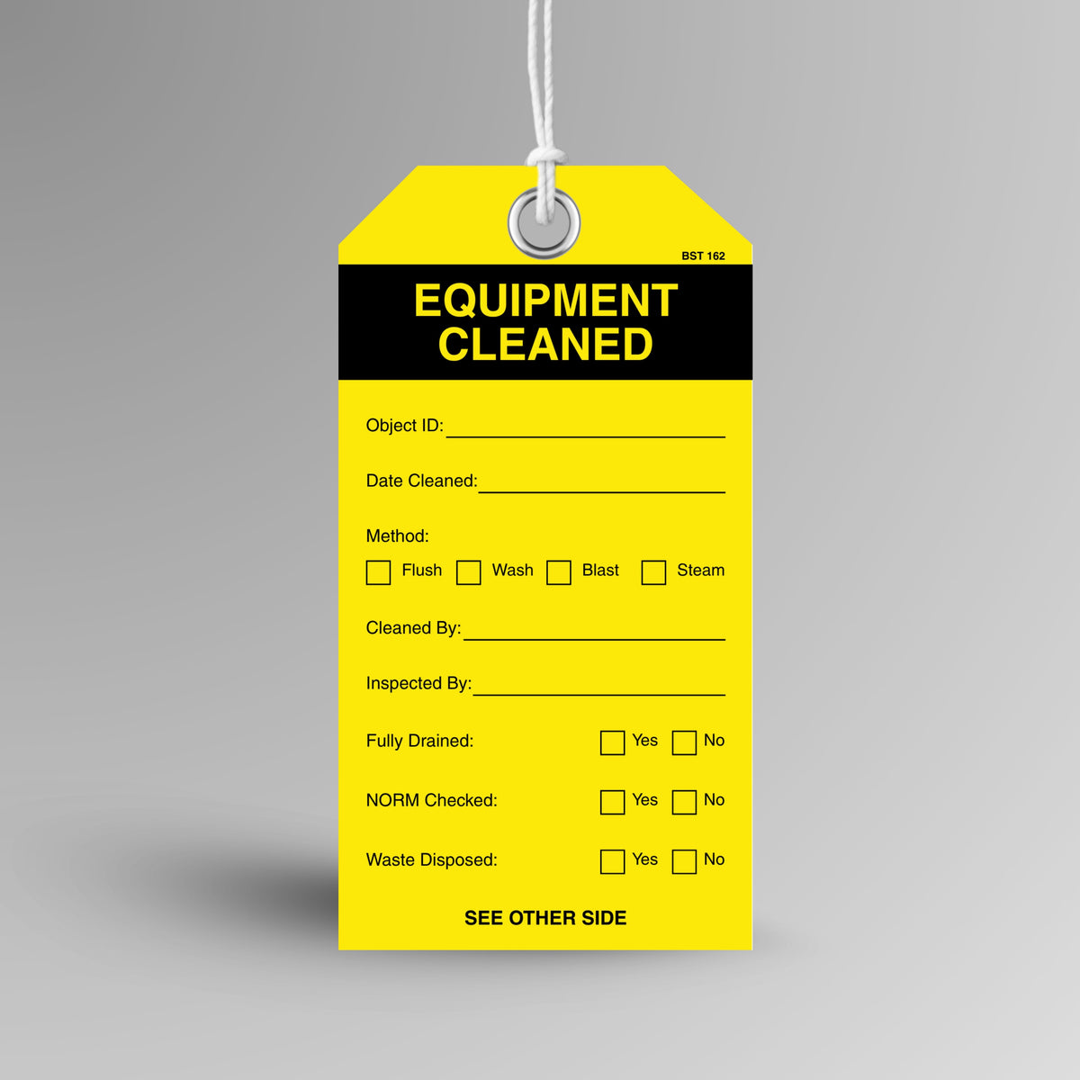 Yellow and black BST 162 Equipment Cleaned tag hanging from white string through a metal eyelet, with object ID, method, fully drained, NORM checked and waste disposed fields.