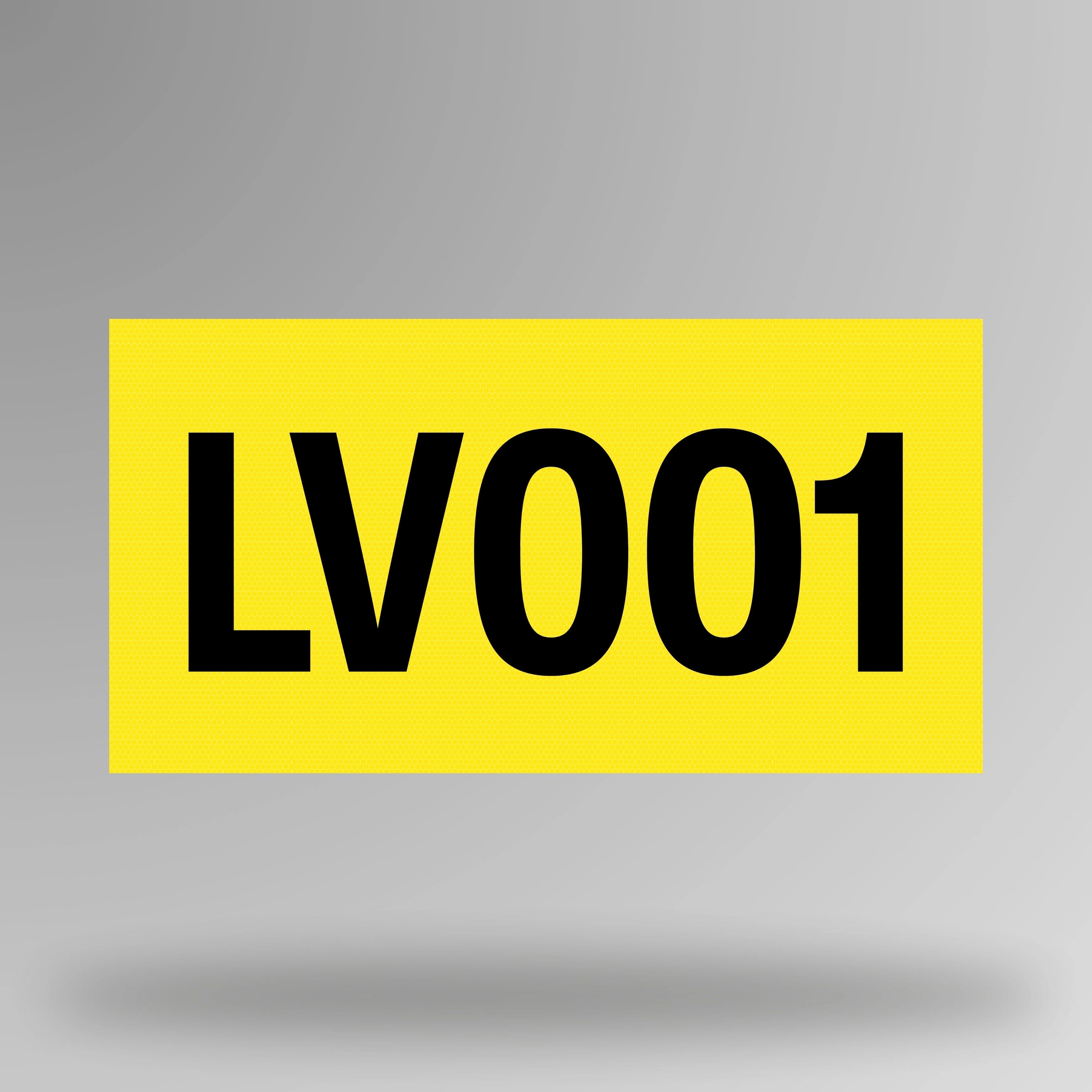 Yellow reflective vinyl asset decal shown in upright position with black printed asset number visible against bright yellow background